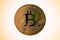 Golden color bitcoin on a golden halo background