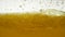 Golden color oil is poured into the tank, near view. Heterogeneous phase. The focus of boiling yellow oil is widespread