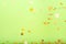 Golden confetti falling on the bold neon green background, holiday celebration backdrop