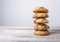 Golden cookie tower with pieces of chocolate on wooden background