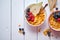 Golden cornflakes with fresh fruits of raspberries, blueberries and pear in ceramic bowl