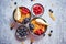 Golden cornflakes with fresh fruits of raspberries, blueberries and pear in ceramic bowl