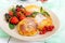 Golden cottage cheese pancakes with fresh berries on a plate on white wooden background.