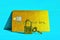 Golden credit card with padlock and key on blue