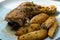 Golden and crispy baked chicken leg with thigh, country-style ham with potato wedges, delicious and hearty homemade food on a