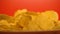 Golden crispy chips closeup, junk food with flavor enhancers, health risks