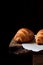 Golden croissants of yeast dough on the edge of the wooden table