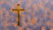 Golden cross on a rusted corroded metal or steel sheet background
