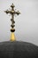 A golden cross sits on top of a church dome