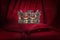 Golden crown on red velvet background Royal symbol  coronation