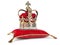 Golden crown on red velvet pillow for coronation. Royal symbol of british UK monarchy