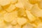 Golden crunchy chips, food background, close up