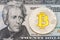 Golden cruptocurrency yellow `bitcoin on twenty dollar banknote