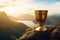 golden cup on a mountain peak, representing overcoming challenges