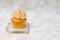 Golden cupcake with coconut glaze on top