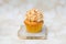Golden cupcake with coconut glaze on top
