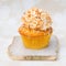 Golden cupcake with coconut glaze on top