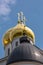 Golden cupola of Russian orthodox church under blue sky