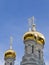 Golden cupolas of orthodox temple in spa city of Karlovy Vary, Czechia.