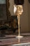 Golden decorated chalice on wooden table and divine light