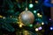 Golden decoration globe on christmas tree close up