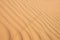 Golden desert sand texture as background, lizard footprints