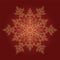 Golden detailed snowflake on red background