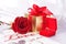 Golden diamond ring with gift box and red rose