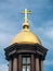 Golden dome of the chapel with a bird at the top of the cross