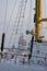 The golden dome of Isaac cathedral through old moored sail boat at frosty day, Winter landscape of St. Petersburg