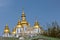 Golden domes on the blue temple on the background of the sky.