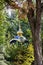 Golden domes of Christian chapel surrounded by green trees