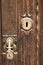 Golden doorknocker with modernist style on old wooden door