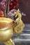 Golden dragon horse statue beside gold incense burner