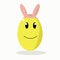 Golden Easter egg with rabbit ears on a white background.yellow egg smiles
