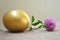 Golden Easter egg and red clover flower