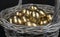 Golden eggs lie in a silver basket, close-up