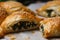 Golden flaky bourekas stuffed with spinach and feta cheese, with steam rising from the center