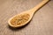 Golden Flax seed. Spoon and grains over wooden table.