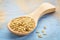 Golden flax seeds on wooden spoon