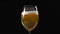 Golden foamy beer is poured to the glass in slow motion, beer glass in dark background, bubbles in beer, light beer