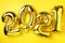 Golden foil balloons made numbers 2021 on yellow background with light bokehs. Banner, copy space. Happy new year celebration