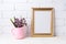 Golden frame mockup with purple flowers in pink rustic pitcher