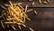 Golden French Fries Piled on Rustic Wooden Table, Copy Space