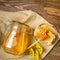 Golden fresh honey in a glass jar and honeycombs wooden table. The concept of natural products. Brown rustic background.