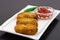 Golden fried crisp cutlets served with tomato sauce