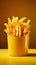 Golden fries in a yellow fast food box, isolated