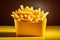 Golden fries in a yellow fast food box, isolated