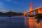 Golden Gate Bridge view from the hidden and secluded rocky Marshall's Beach at sunset in San Francisco, California