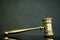 Golden gavel on wooden table,legal books background